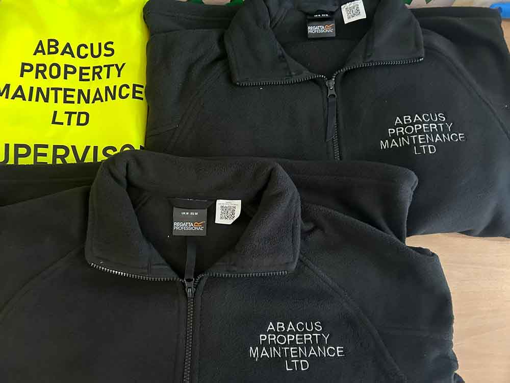 Winter branded workwear high vis and black fleeces for Abacus Property Maintenance